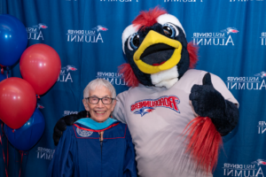 Anna Jo Garcia Haynes stands with Rowdy the Roadrunner at the Master of Arts in Teaching Hooding Ceremony, May 8th, 2023.